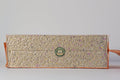 Rectangular block of cat litter and green logo on a light gray background