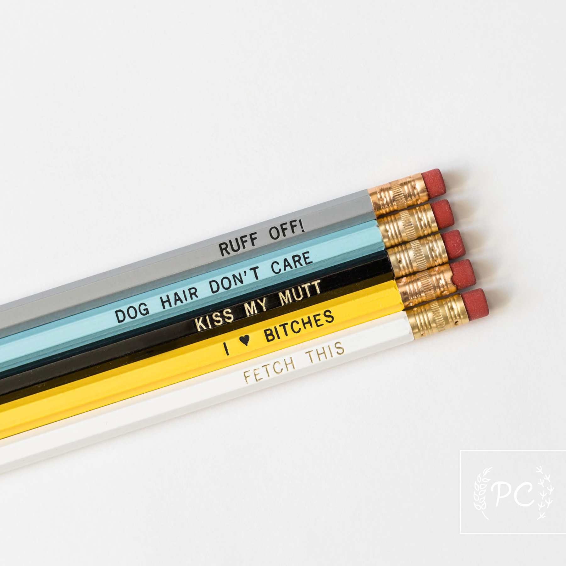Set of pencils with dog themed text on a white background