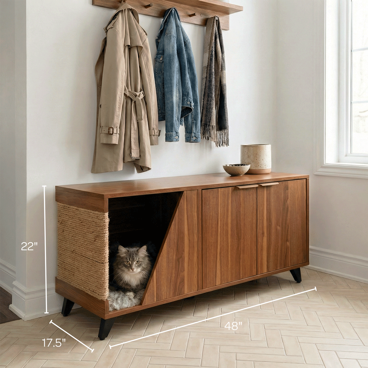 Wooden cabinet with a cat shelter and coats hanging above in a room.
