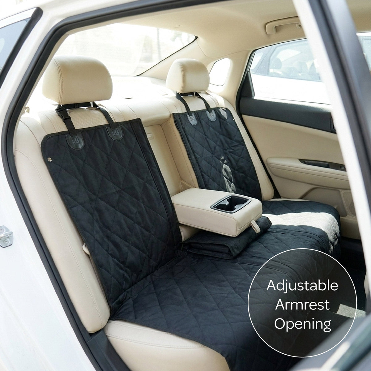 Car seat cover with adjustable armrest opening installed in a vehicle.