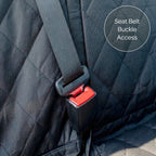 Close-up of a car seat with a red seat belt buckle on a dark quilted fabric background.