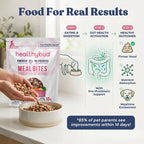 Healthybud meal bites packaging with a bowl of pet food and promotional text on a kitchen counter.
