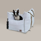 Dog inside a white pet carrier on a beige background