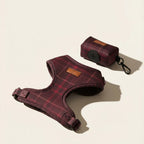Red plaid dog harness and matching dog waste holder on a beige background
