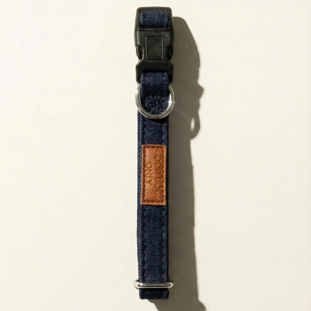 Navy blue dog collar with a leather patch on a beige background