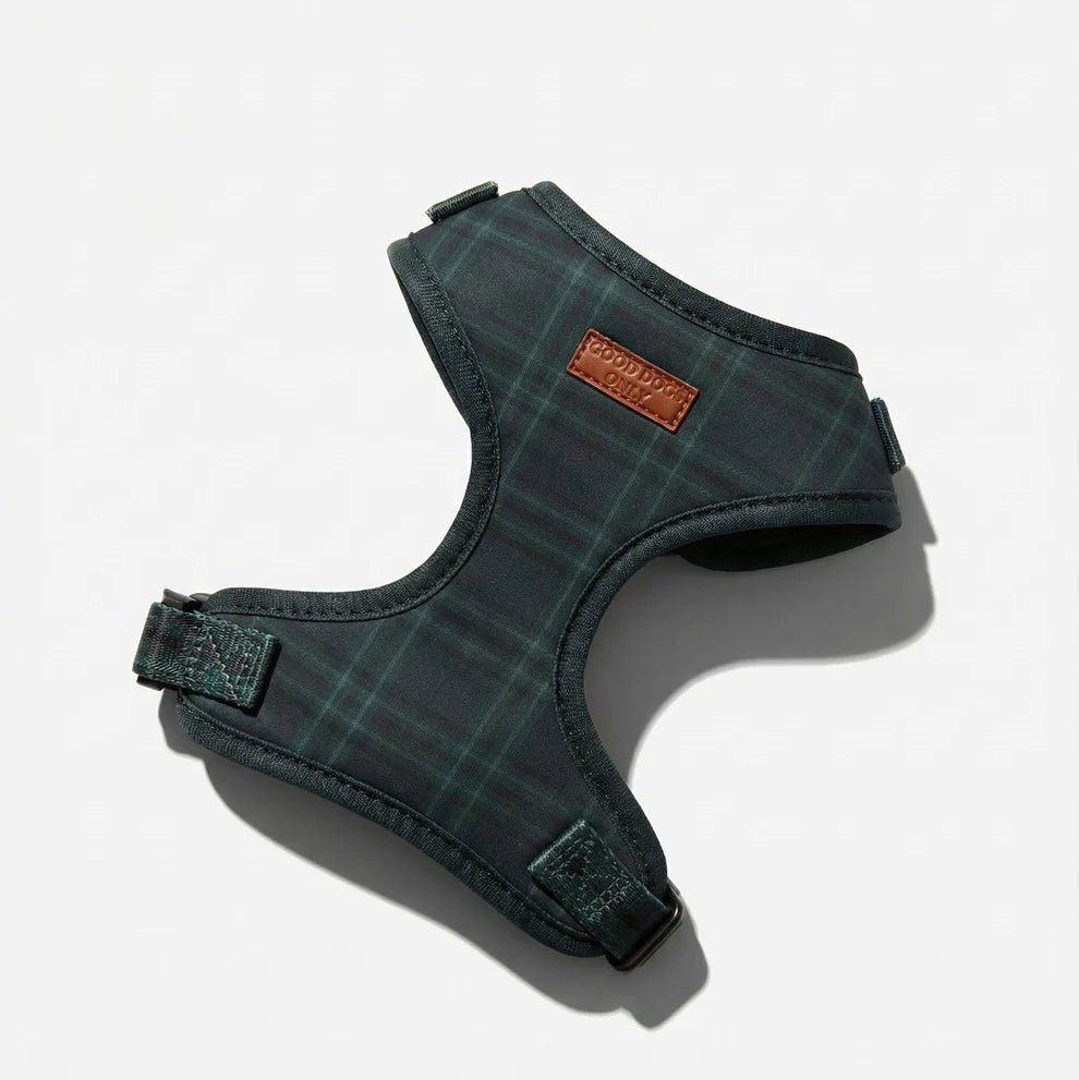 Green plaid dog harness with a brand label on a white background