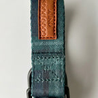 Teal dog collar with a brown leather patch displaying 'Good Dogs Only' on a light gray background.