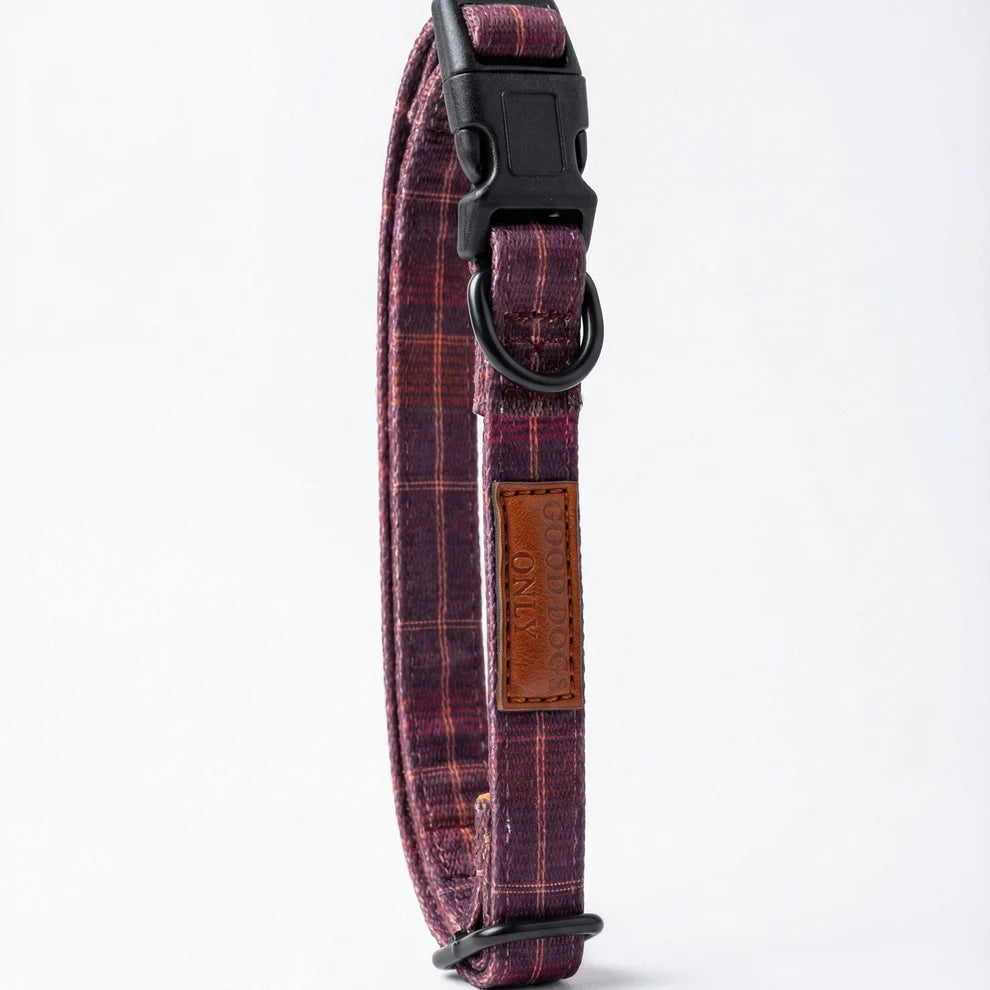 Plaid patterned dog collar with a brown leather patch on a white background