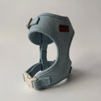 Blue dog harness on a light gray background