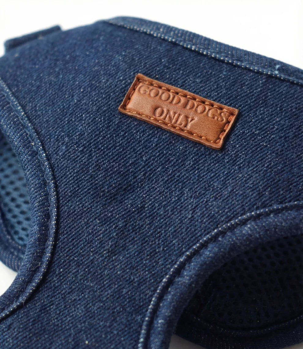 Blue denim dog harness with a brown leather label reading 'Good Dogs Only' on a white background.