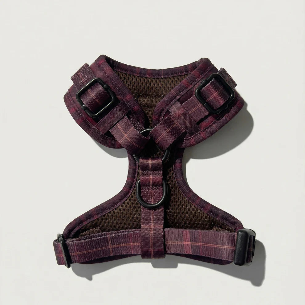 Plaid patterned dog harness on a light gray background