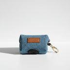 Denim waste bag holder with a leather tag and keychain on a white background