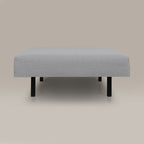 Gray upholstered ottoman on a beige background