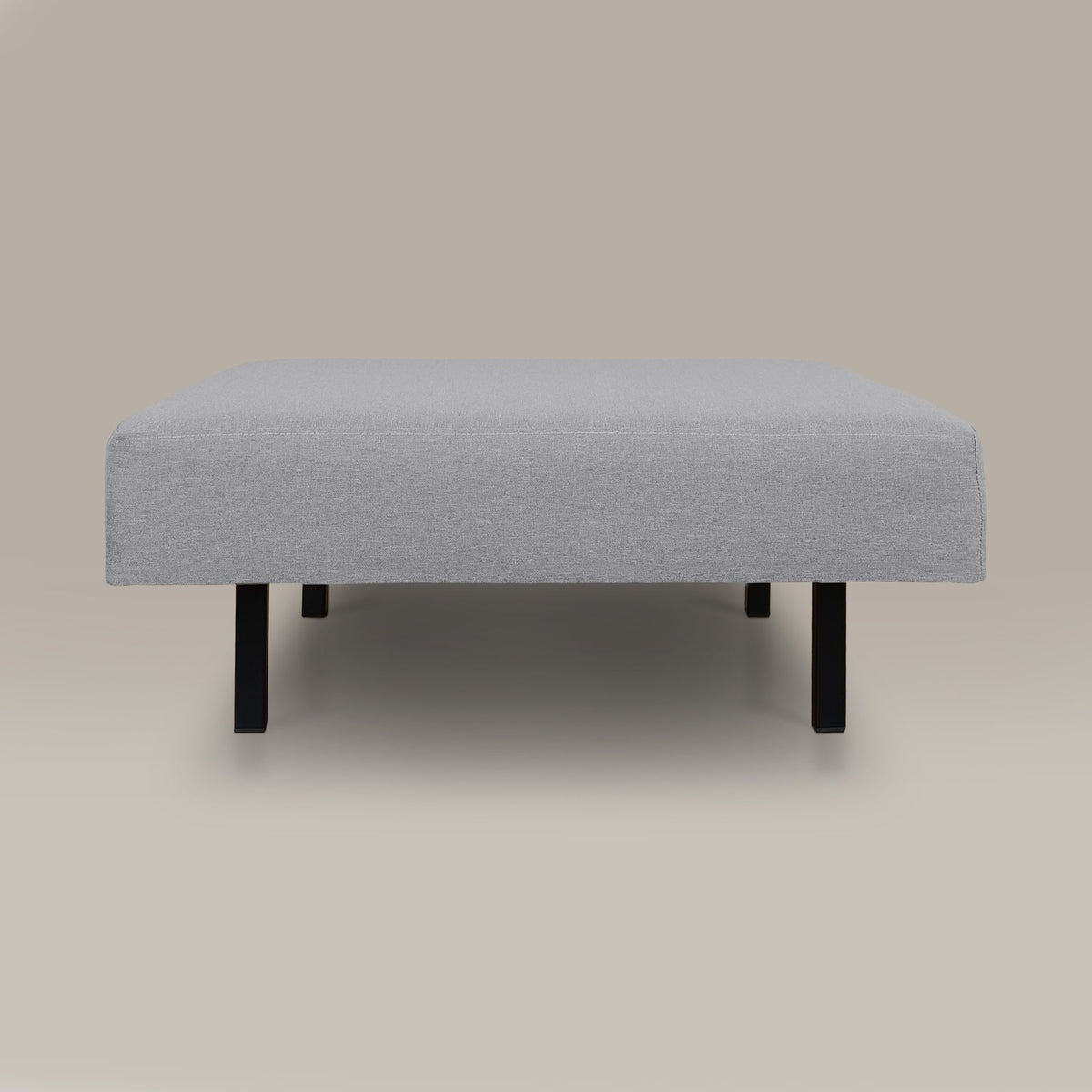 Gray upholstered ottoman on a beige background