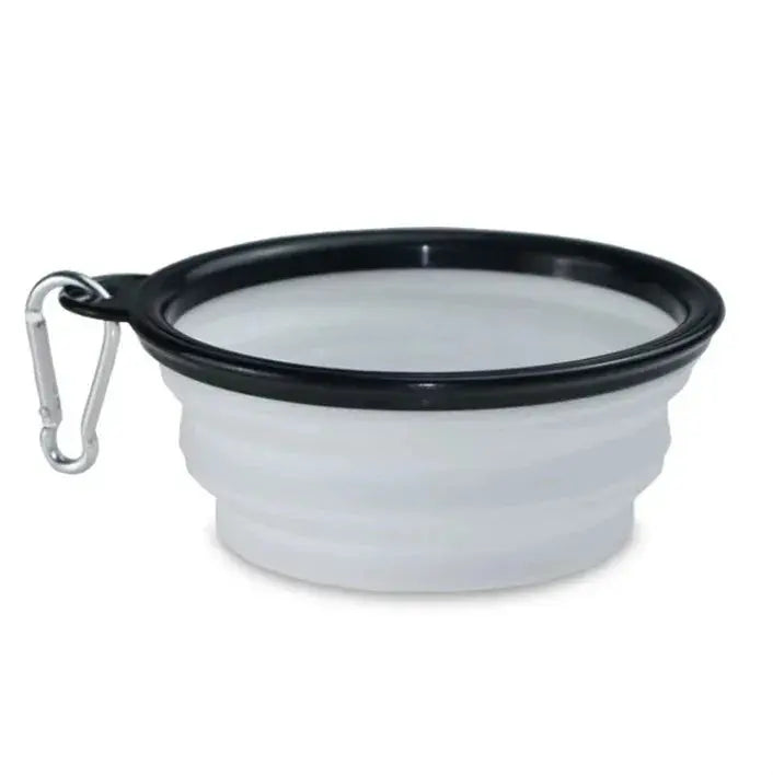 Collapsible white silicone bowl with black rim and carabiner clip on a white background
