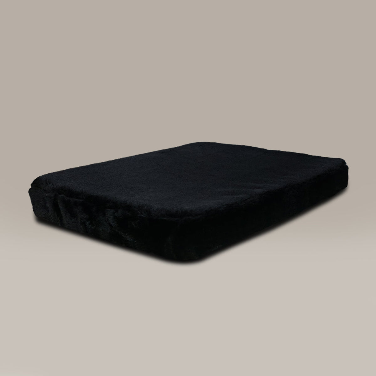 Black dog bed on a beige background