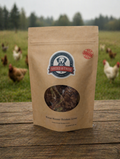 Kraft paper package of dried chicken liver with a brand logo, set against a background of chickens in a field.