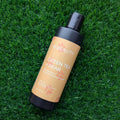 Bottle of OC Beauty Green Tea Pear' pet shampoo on grass