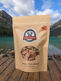Kraft paper package of 'Dried & True' trout jerky with a scenic mountain lake background