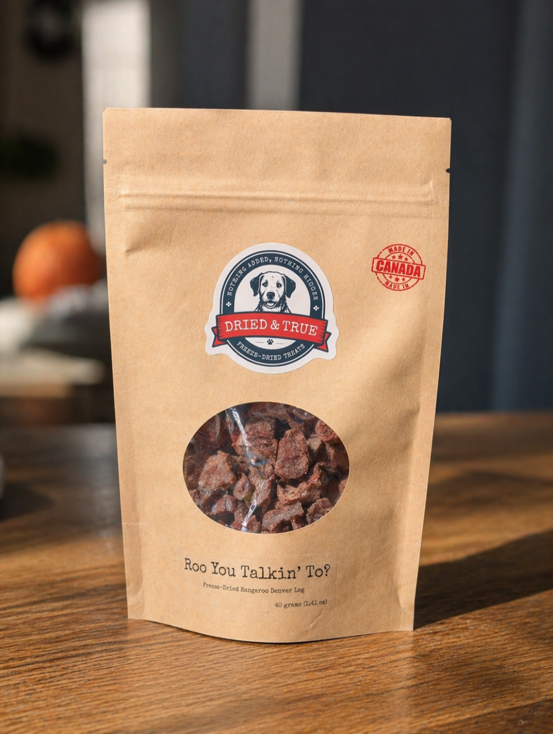 Kraft paper pet treat bag with brand logo on a wooden surface
