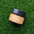 Jar of paw balm on a grass background