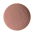 A round, light sage green outdoor disc with embossed branding for 'KUMA OUTDOOR GEAR' and a geometric mountain logo, shown on a plain white background.