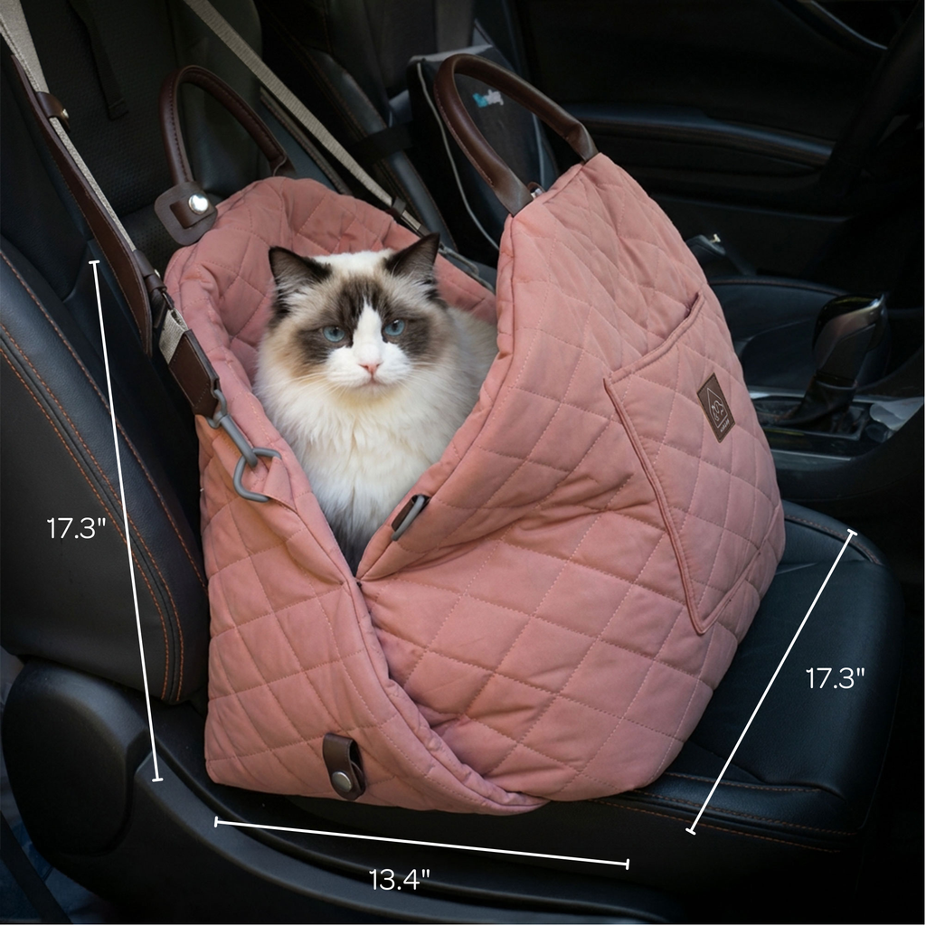 Cat in a pink quilted pet carrier in a car