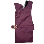 Burgundy dog rain coat with gold buckle on a white background