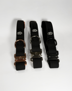 3 black dog collars on a grey background