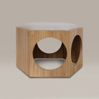 Wooden pet bed with circular cutouts and a cushion on a beige background