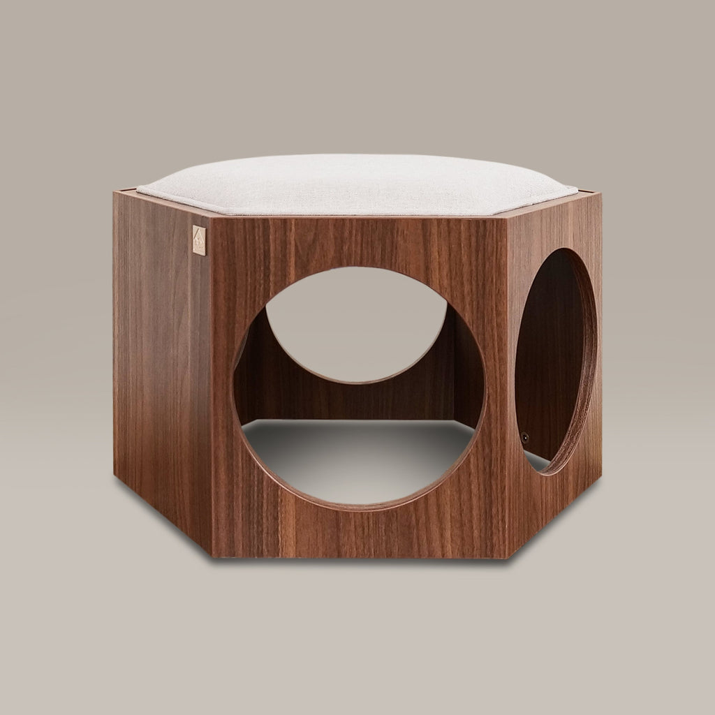 Wooden pet bed with white cushion on a beige background