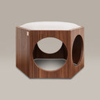 Wooden pet bed with white cushion on a beige background