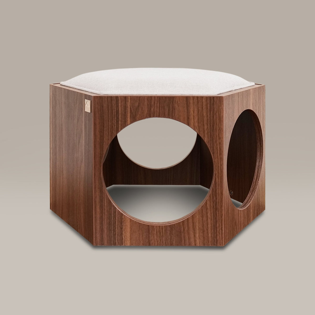 Wooden pet bed with white cushion on a beige background