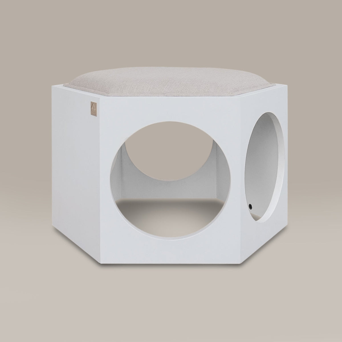 White hexagonal pet bed with circular holes on a beige background