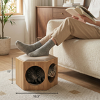 Person sitting on a couch with a cat in a wooden pet house, dimensions displayed.