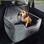 Dog sitting in a gray pet seat in a car