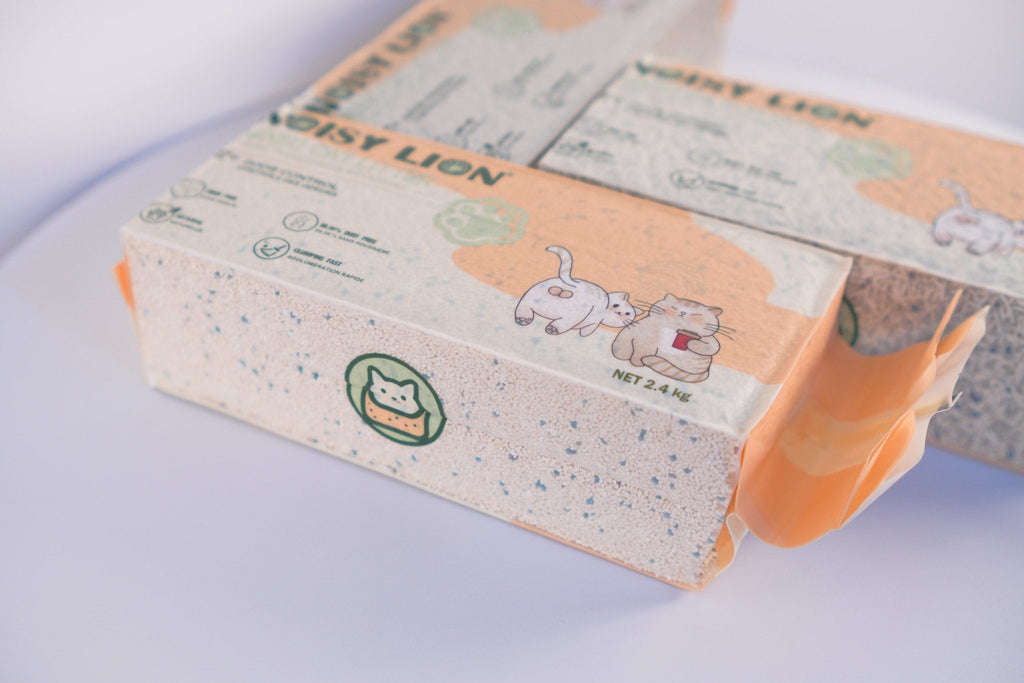 Pack of cat litter with cartoon illustrations on a light background